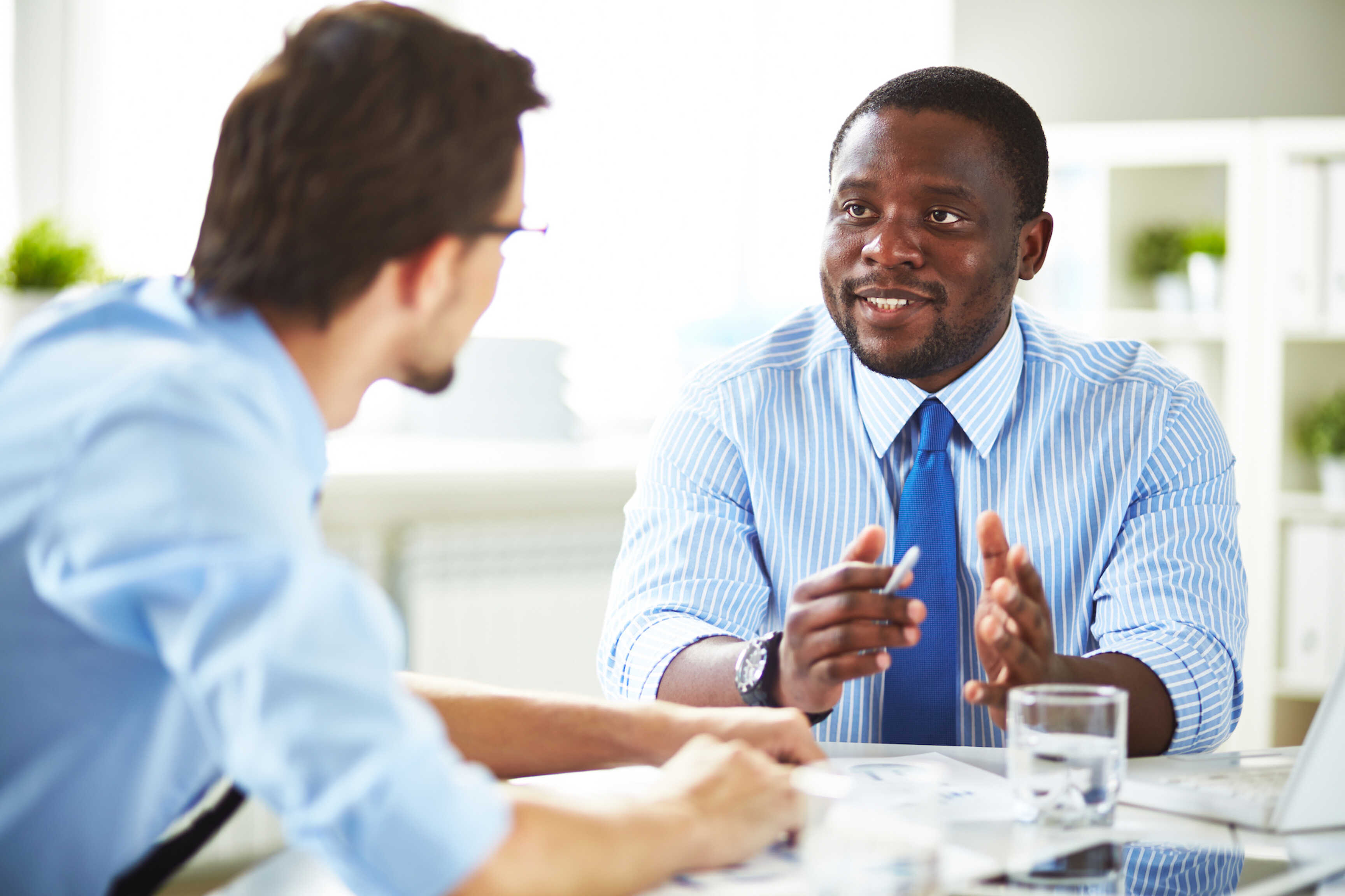 Two Professionals Engaged In Office Meeting